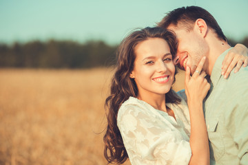 Young couple in love outdoor.Stunning sensual outdoor portrait of young stylish fashion couple posing in summer in field 