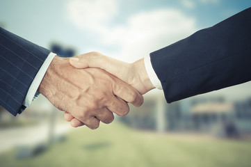 Successful business people handshaking closing a deal 
