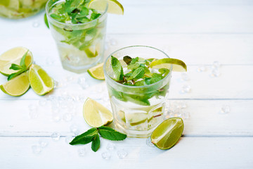 Cold fresh lemonade drink on a wooden background