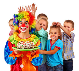 Clown keep cake on birthday with group children. Clown and children posing at camera. Isolated.