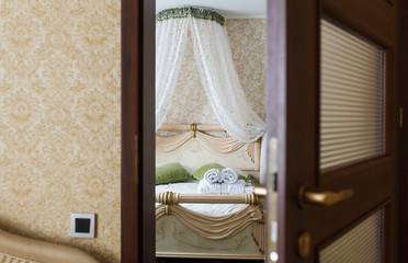 Half open door of a hotel bedroom