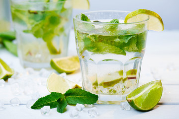 Cold fresh lemonade drink on a wooden background