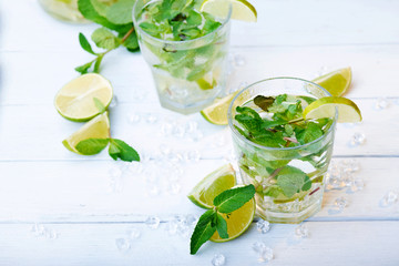 Cold fresh lemonade drink on a wooden background