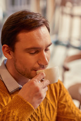 Content man drinking coffee 