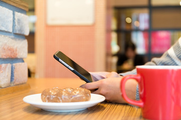 Woman use of cellphone at cafe