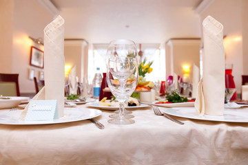 Table in a restaurant with glasses, napkins and cutlery