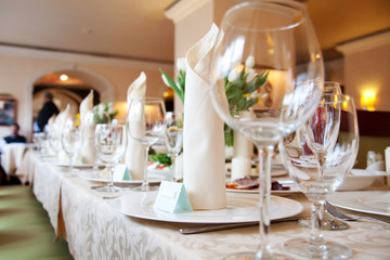 Table in a restaurant with glasses, napkins and cutlery