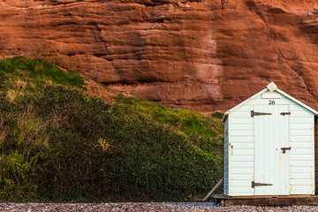 Beach hut row in pastel colors, red rock background