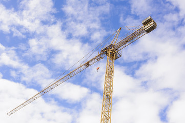 Yellow Industrial Crane   Against Blue Sky