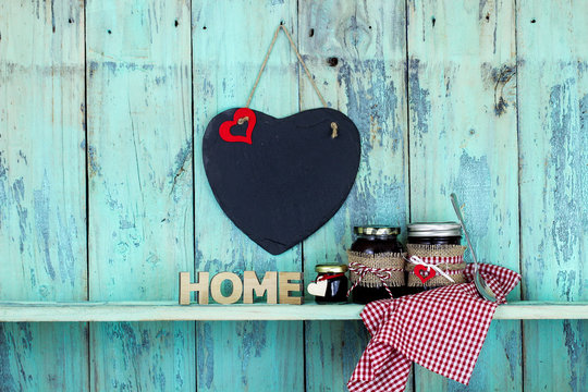 Blank slate heart hanging over jars of jam and the word HOME