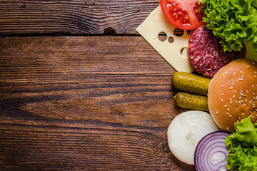 Ingredients for hamburgers on wooden table, border background - obrazy, fototapety, plakaty