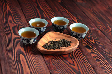 Mug of green tea on wooden background. Imitation Cat's footprints.