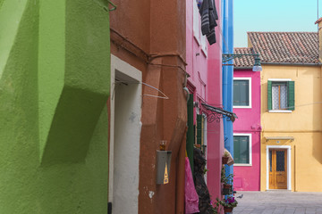 Fototapeta na wymiar Venice landmark, Burano island canal, colorful houses and boats