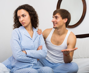 Smiling husband trying to reconcile with wife