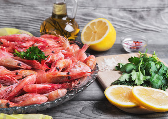 On a dark wooden table dish with shrimp raw