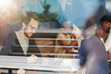 Couple on a coffee date at busy modern cafe