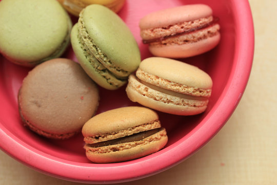 Macarons on pink plate