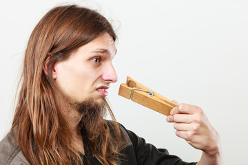 Man with clogged nose by clothespin