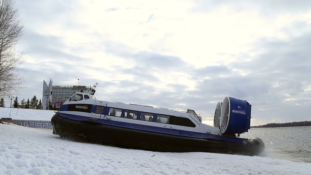 Passenger hovercraft departs from the shore on the river Volga in Russia in the winter

