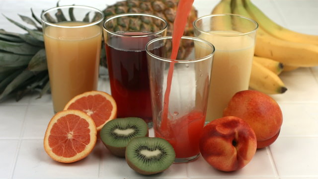 Fruit juice pouring into glass, slow motion