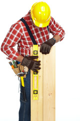Hands of worker with wooden plank and ruler.