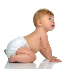 Six month infant child baby toddler sitting in diaper looking at