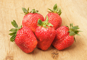 Red fresh strawberry fruits on wooden table.