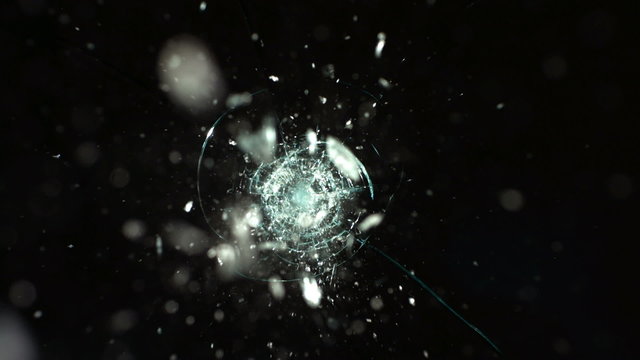 Bullet hitting safety glass, slow motion