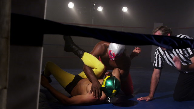 Masked wrestler pins opponent