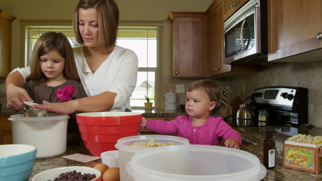 Mom baking with daughters