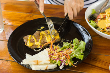 Grilled steaks, baked potatoes and vegetable salad