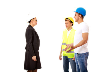 Female engineer talking with two builders
