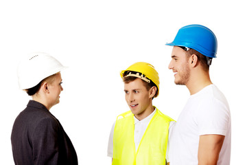Female engineer talking with two builders