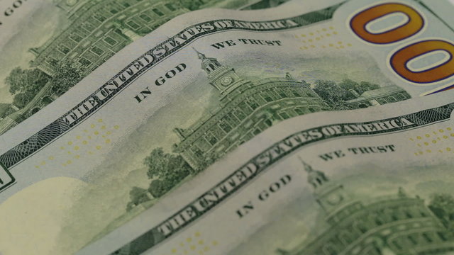 Cash money background. Benjamin Franklin portrait on 100 US dollar bill close up, the image is rotated