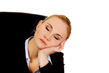 Tired business woman sleeping leaning on hand