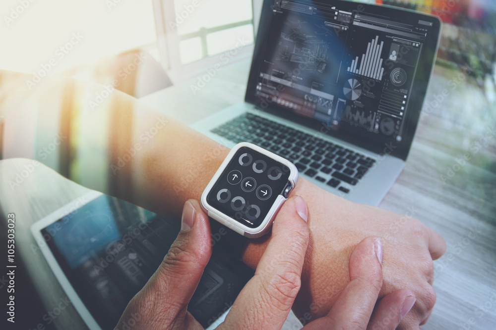 Poster website designer working with smart watch and digital tablet and