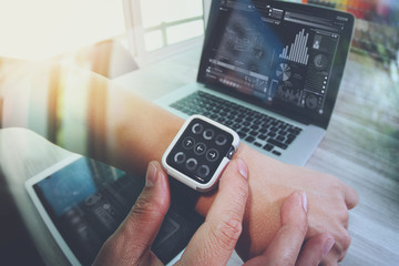 Website designer working with smart watch and digital tablet and