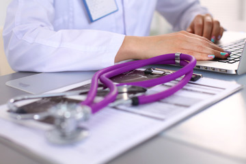 Portrait of happy medical doctor woman in office