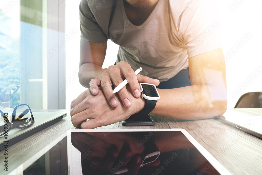 Poster website designer working with smart watch and digital tablet an
