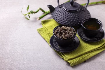 Foto op Aluminium Green tea in bowl and traditional asian tea set  on grey slate © daffodilred
