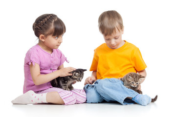 Fototapeta na wymiar Kids girl and boy sitting on the floor, playing with small kittens - isolated