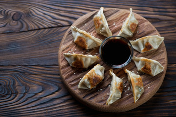 Gyoza dumplings on a wooden rustic serving board