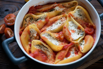 Close-up of conchiglioni baked with cottage cheese