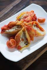 Conchiglione baked with cottage cheese stuffing and tomato sauce