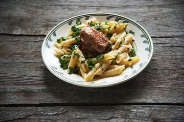 Penne pasta in tomato sauce with chicken, tomatoes decorated  parsley