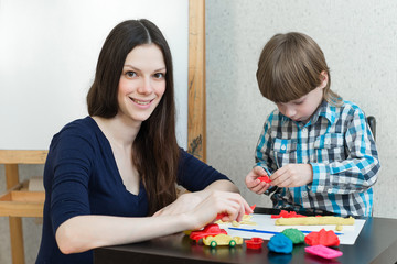 child kid boy and mother play colorful clay