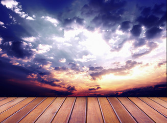 Wood table top on over sunset background 