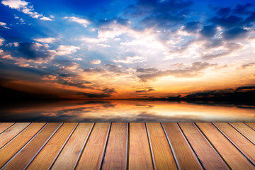 Wood table top on over sunset background [Blur and Select focus background] 