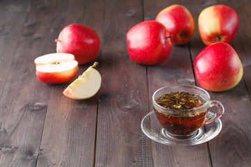 Herbal tea in glass and apples