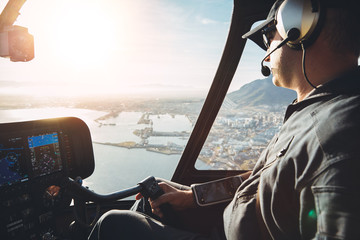 Pilot in cockpit of a helicopter - obrazy, fototapety, plakaty